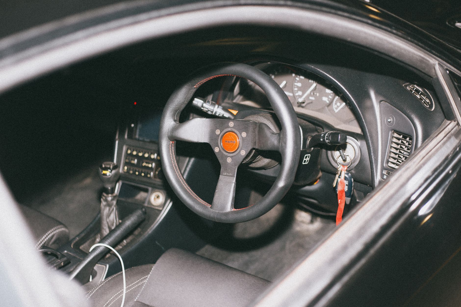 A car interior showing the gear stick and controls, the workspace where clutch control is learned